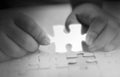 Two hands holding jigsaw puzzle piece glowing white glow piece missing from the components, Abstract concept of business with