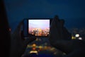 Two Hands Holding a Mobile with Night View of Hong Kong City Skyscrapers from The Peak Royalty Free Stock Photo