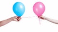 Two hands holding pink and blue balloons Royalty Free Stock Photo