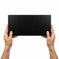 Two hands holding a sleek black tablet or digital device Royalty Free Stock Photo