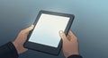 Two hands holding a tablet with a blank white screen. The tablet has a dark frame Royalty Free Stock Photo