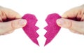 Two hands holding two halves broken pink heart into two parts together isolated on white background, romantic,dating Royalty Free Stock Photo