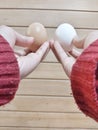 two hands holding white and brown eggs Royalty Free Stock Photo