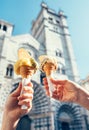 Two hands with ice cream on the San Lorenco Cathedral backgroun Royalty Free Stock Photo