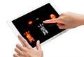 Two hands interact with a tablet screen displaying PET scan images, highlighting metabolic activity in bright red and yellow