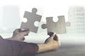 Two hands join together two pieces of puzzle, concept of business and team work Royalty Free Stock Photo