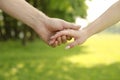 Two hands of a loving couple on nature Royalty Free Stock Photo