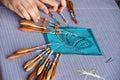 Two hands make bobbin lace on pillow Royalty Free Stock Photo