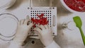 Scientist with gloves and lab coat making capsules in the laboratory