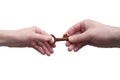 Two hands, male and female pass each other the old key isolated on white background.