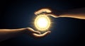 Two hands, one from each side, surround a glowing, radiant orb emitting bright Royalty Free Stock Photo