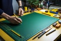 Two hands over a cutting mat and many tools and supplies around it. View from above. Copy space Royalty Free Stock Photo