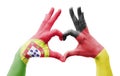 Two hands of a person painted with the flags of Germany and Portugal forming a heart
