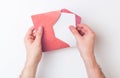 Two hands putting a letter into an envelope Royalty Free Stock Photo