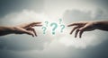 Two hands reaching towards each other with question marks floating in the cloudy background Royalty Free Stock Photo