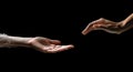 Two hands reach out to each other. Hands in motion towards on a black background Royalty Free Stock Photo