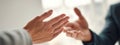 Two hands reaching out in a moment of connection during an important conversation in a bright, modern office Royalty Free Stock Photo