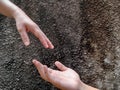 Two hands reaching out to each other, isolated on dark cemented wall Royalty Free Stock Photo