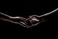 Two hands reaching toward. Helping hand outstretched for salvation on  black background. Close up of man and Royalty Free Stock Photo