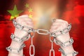 Two hands shackled a metal chain on China flag. Freedom concept