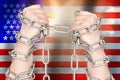 Two hands shackled a metal chain on USA flag. Freedom concept