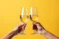 Two Hands Toasting with champagne glasses isolated on yellow background Royalty Free Stock Photo