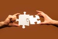 Two hands trying to connect couple puzzle. Businessman hand connecting jigsaw puzzle. Closeup hands of man connecting Royalty Free Stock Photo