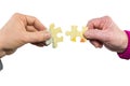 Two hands uniting fitting puzzle pieces Royalty Free Stock Photo