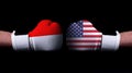 Two hands of wearing boxing gloves with USA and Indonesia flag. Boxing competition concept. Confrontation between two countries