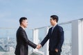 Two handsome businessmen greeting each other in the street Royalty Free Stock Photo