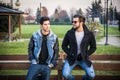 Two handsome young men, friends, in a park Royalty Free Stock Photo