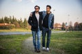 Two handsome young men, friends, in a park Royalty Free Stock Photo