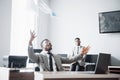 Two handsome cheerful african american businessman celebration successful with throwing paper in workplace Royalty Free Stock Photo