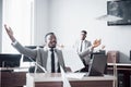 Two handsome cheerful african american businessman celebration successful with throwing paper in workplace Royalty Free Stock Photo