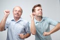 Two handsome male friends dancing on birthday party Royalty Free Stock Photo