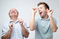 Two handsome male friends dancing on birthday party Royalty Free Stock Photo