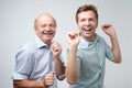 Two handsome male friends dancing on birthday party. Royalty Free Stock Photo