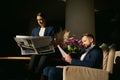 Two handsome people, middle aged Caucasian man and beautiful elegant woman in business suit, colleagues, business partners reading Royalty Free Stock Photo