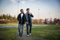 Two handsome young men, friends, in a park Royalty Free Stock Photo