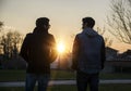 Two handsome young men, friends, in a park Royalty Free Stock Photo