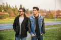 Two handsome young men, friends, in a park Royalty Free Stock Photo