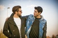 Two handsome young men, friends, in a park Royalty Free Stock Photo