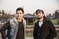 Two handsome young men, friends, in a park Royalty Free Stock Photo