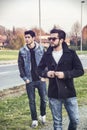 Two handsome young men, friends, in a park Royalty Free Stock Photo