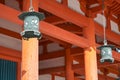 Hanging copper lanterns on the background of vermilion columns. Heian-jingu Shrine. Kyoto. Japan Royalty Free Stock Photo