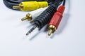 Two hanks of cables with multi-colored plugs a tulip. Black cord. White monophonic background. Royalty Free Stock Photo