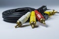 Two hanks of cables with multi-colored plugs a tulip. Black cord. White monophonic background. Royalty Free Stock Photo