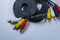 Two hanks of cables with multi-colored plugs a tulip. Black cord. White monophonic background. Royalty Free Stock Photo