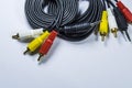 Two hanks of cables with multi-colored plugs a tulip. Black cord. White monophonic background. Royalty Free Stock Photo