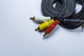 Two hanks of cables with multi-colored plugs a tulip. Black cord. White monophonic background. Royalty Free Stock Photo